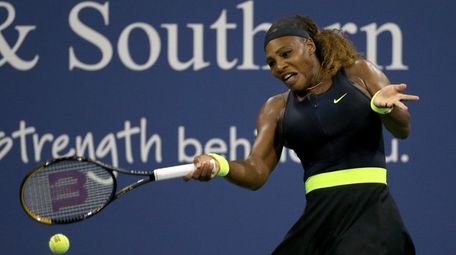 Serena Williams returns a shot to Maria Sakkari