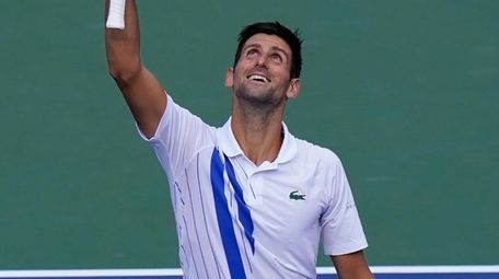 Novak Djokovic reacts to winning his match with