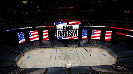 An End Racism sign is displayed before Game