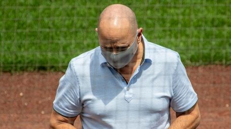 Yankees GM Brian Cashman sports a mask during