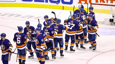 The Islanders celebrate their 3-2 victory against the