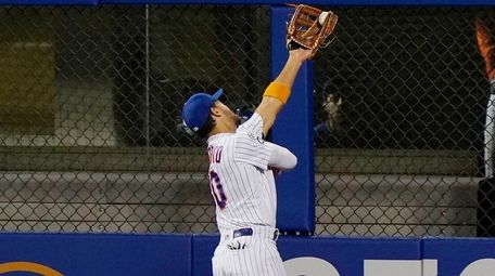 The Mets' Michael Conforto catches a fly ball