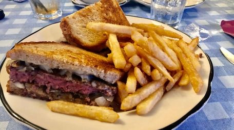 A patty melt with sautéed onions, Swiss cheese