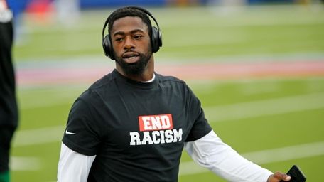Jets free safety Marcus Maye warms up before