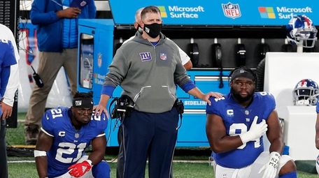 Giants head coach Joe Judge stands with Jabrill