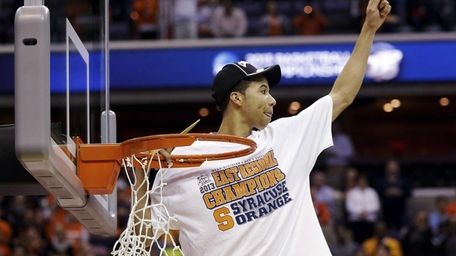 Syracuse guard Michael Carter-Williams celebrates after cutting down