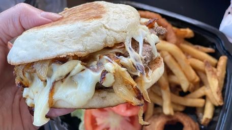 A French onion burger topped with melted mozzarella