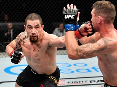 Robert Whittaker of New Zealand punches Darren Till