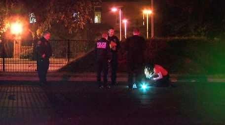 Suffolk County police investigate at the scene where