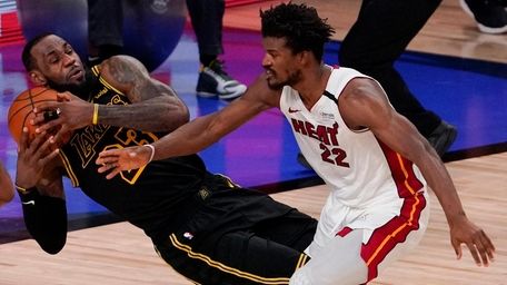 Lakers forward LeBron James pulls a rebound away
