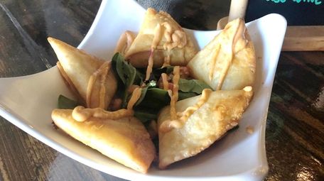 Potato and cheese empanadas topped with a house-made