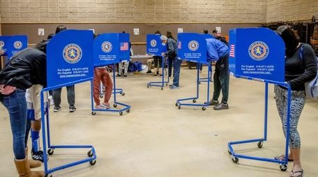 Voters cast their vote during the first day