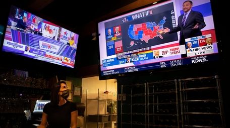 Bartender Sam Schilke watches election results on television