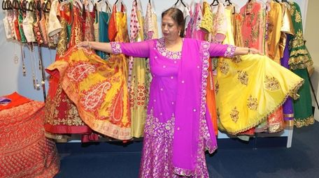 Poonam Jain, owner of Vastra Boutique, shows off