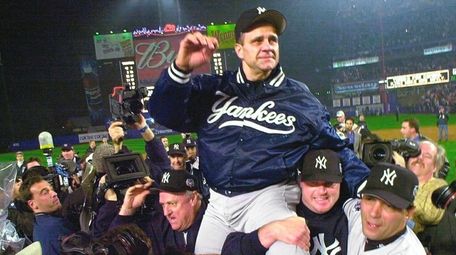 Yankees manager Joe Torre is carried off the