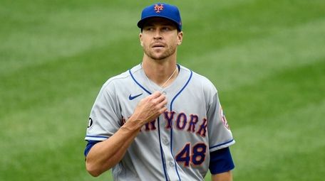 Jacob deGrom of the Mets reacts after giving