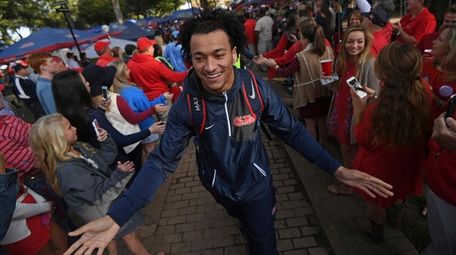Ole Miss tight end Evan Engram greets fans