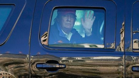 President Donald Trump waves to supporters from his
