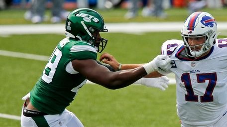 Bills quarterback Josh Allen stiff-arms Jets outside linebacker