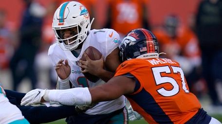Miami Dolphins quarterback Tua Tagovailoa is sacked by