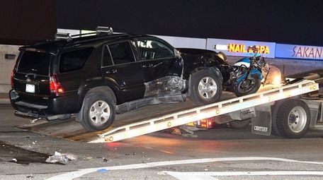An SUV and a motorcycle that were involved