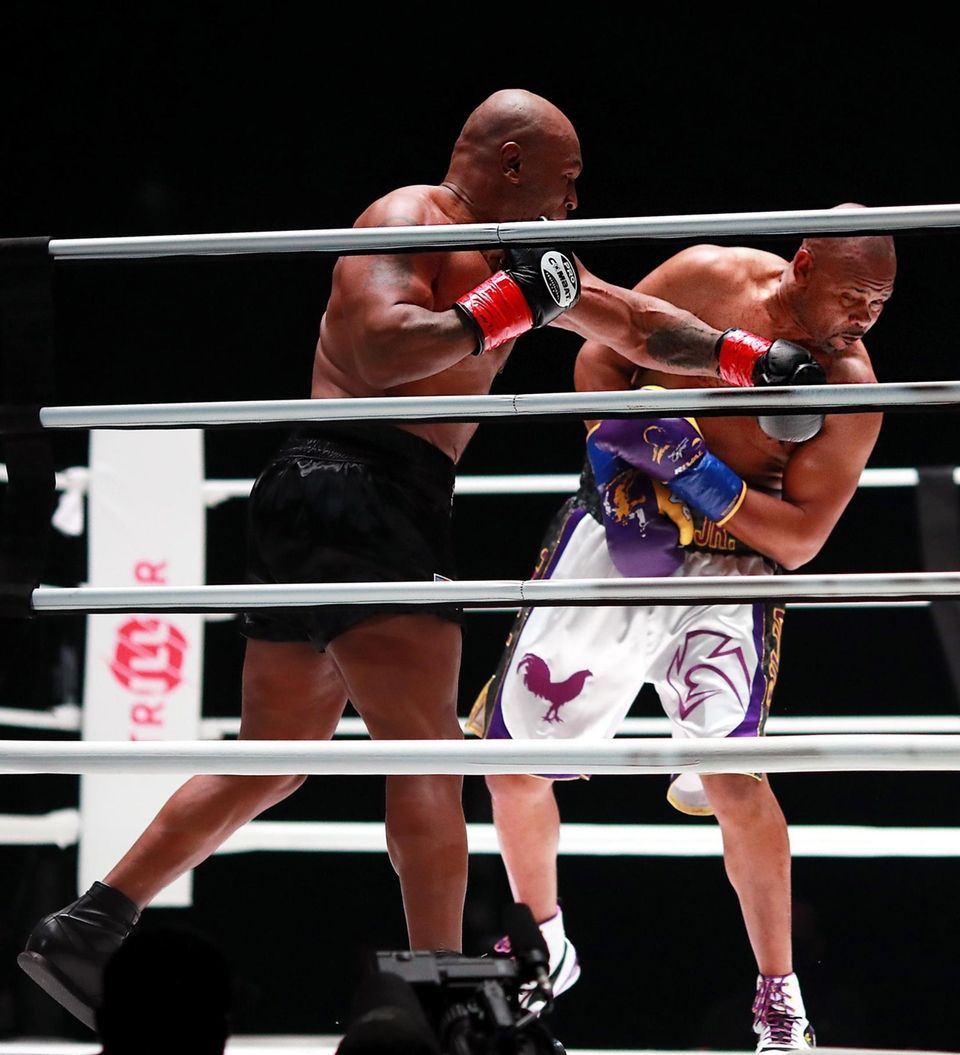 Mike Tyson throws a punch in the third