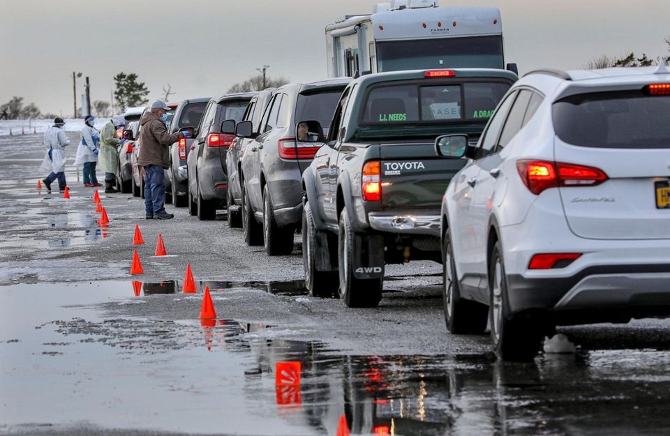 Cars line up at a drive-through COVID-19 testing