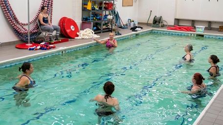 Lorraine Marx-Epstein, in background center, instructs a swim