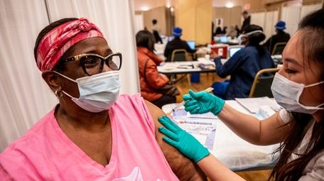 Jeinine Jones-Ford, of Uniondale, gets her first dose