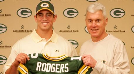 Packers general manager Ted Thompson stands next to