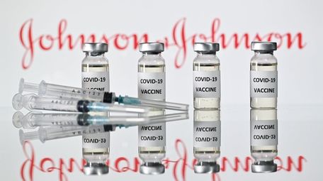 An illustration shows vials with COVID-19 vaccine stickers