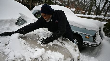 Newton Martin clears the snow in the driveway