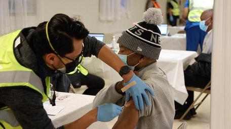 A COVID-19 vaccination is given at Union Baptist