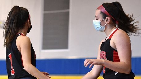 Emily Tierney of Plainedge, right, gets congratulated by