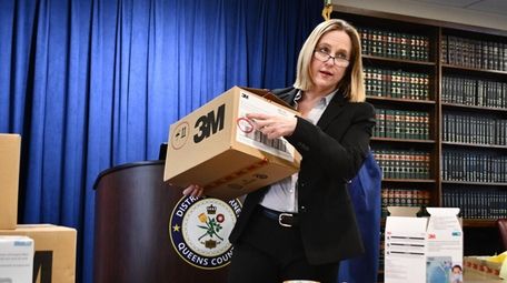 Queens District Attorney Melinda Katz displays a box