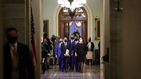 House impeachment managers depart the Senate Chamber at