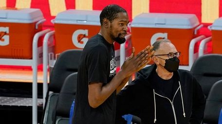 Nets forward Kevin Durant, center, talks with Golden