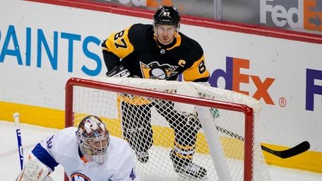Pittsburgh Penguins' Sidney Crosby skates behind the net