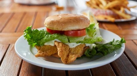 The flounder sandwich with lettuce, tomato, homemade tarter