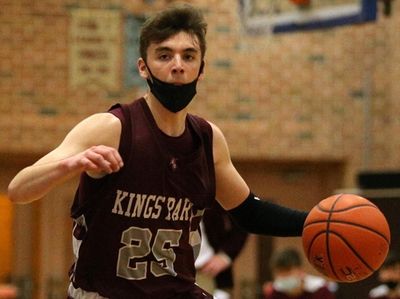 Kings Park guard Jack Garside (25) controls the