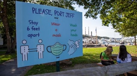 A sign encourages Port Jefferson residents to take
