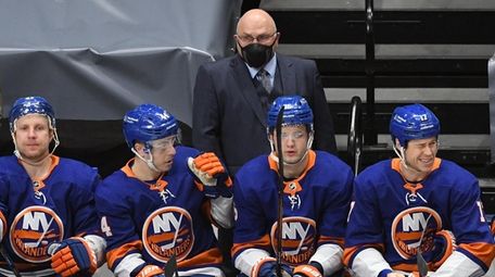 Islanders head coach Barry Trotz looks on in