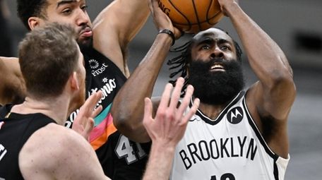 The Nets' James Harden attempts to shoot as
