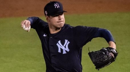 Yankees starting pitcher Corey Kluber throws against the
