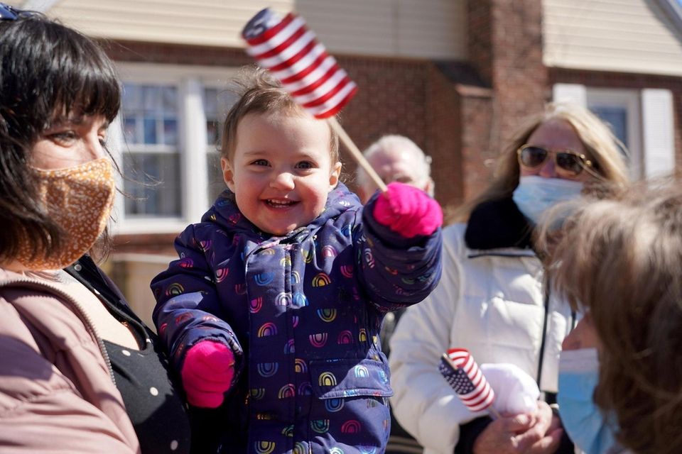 Thea Krolikowski, almost 2-yrs-old, waves an American flag