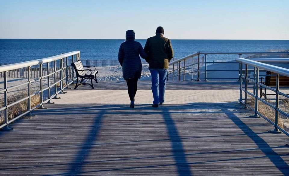 People walk along the boardwalk at Robert Moses
