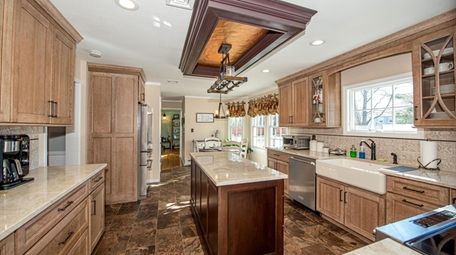 The high-end eat-in kitchen has wood cabinets.