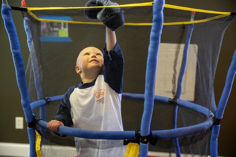 Jude Wood, 2, jumps on the trampoline at