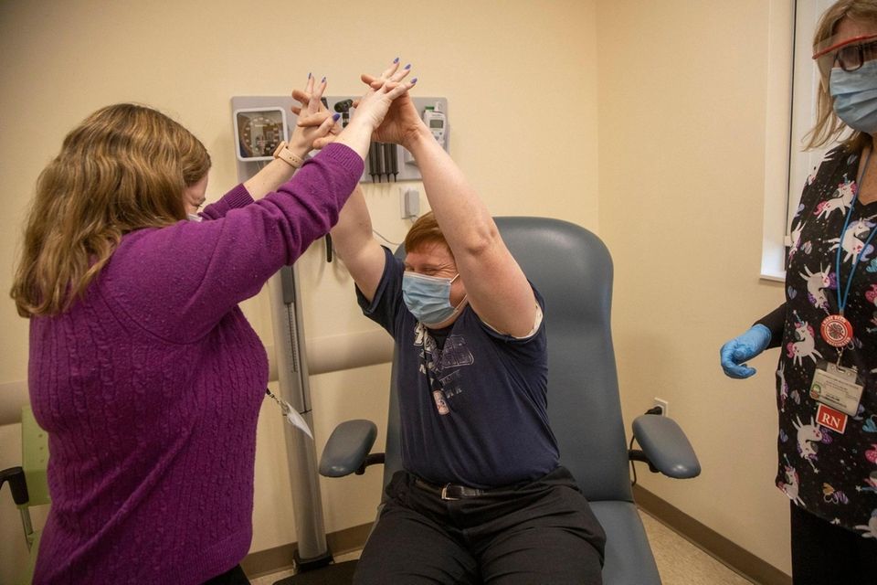 Timothy Schutt hi fives with Dr. Mary Mulqueen