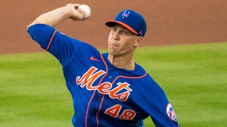 The Mets' Jacob deGrom throws in the first